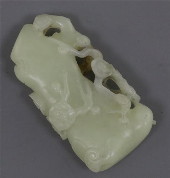 A Chinese pale celadon and russet jade carving of a prunus bough, 5.3cm